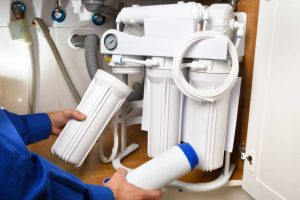 Water Filtration Maintenance Onsite Person Changing Water Filters Visiting Client Facility