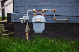 Utility meter and pipes on the outside wall of a home